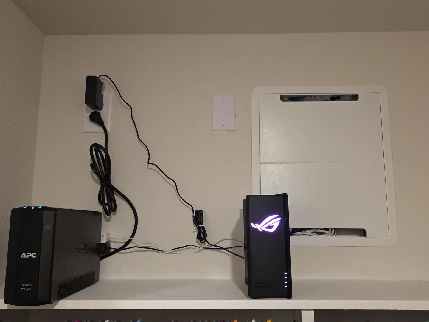 After: network enclosure, ASUS router and UPS organized on the shelf